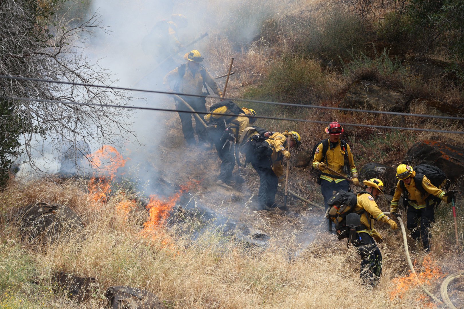 Wildfire explodes across Wine Country as firefighters battle strong winds and steep hills